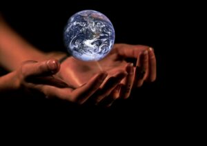 This picture shows 2 hands sustaining the planet. A Reiki Teacher chooses to be of service to this planet.